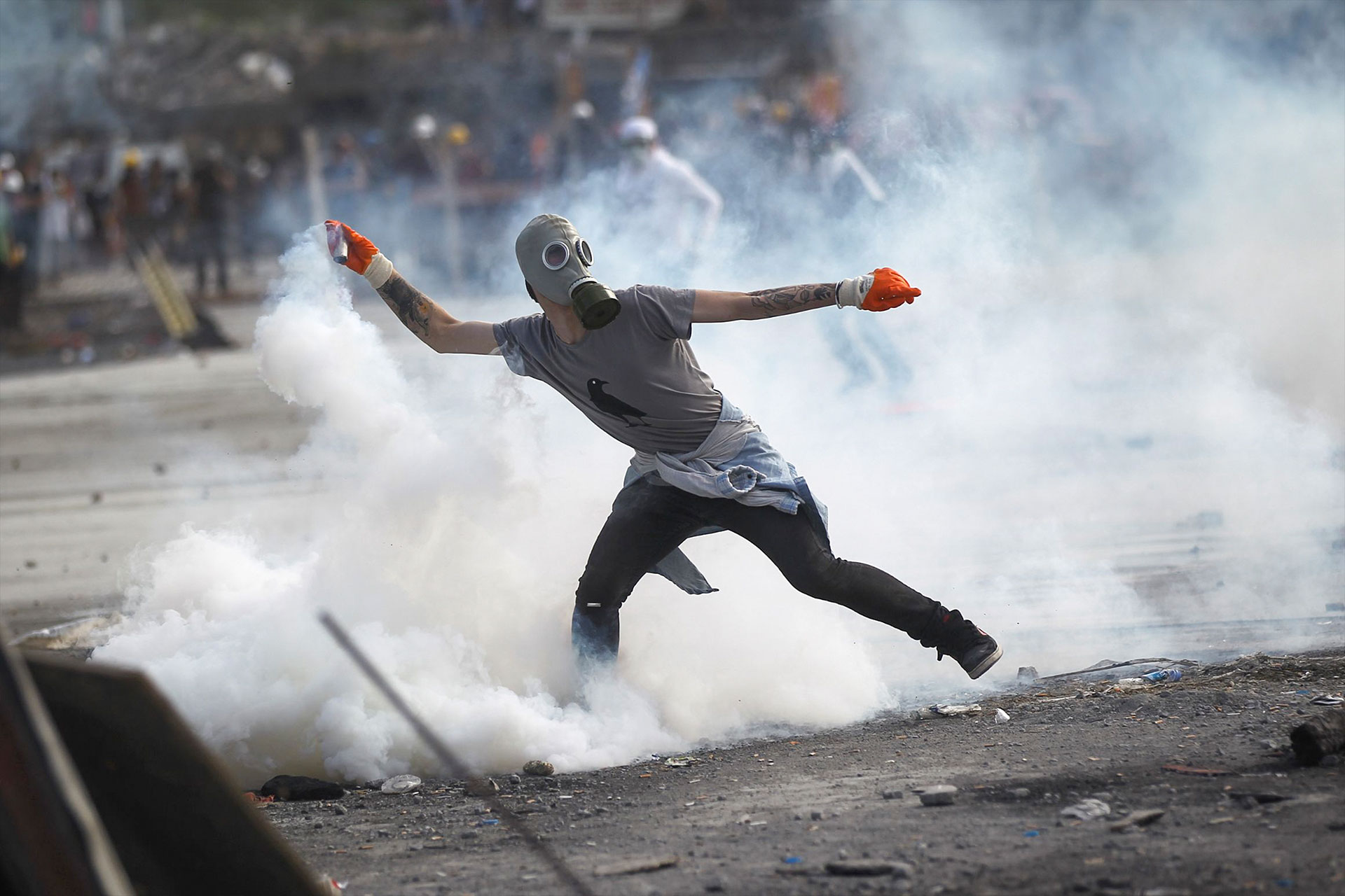 Protester with tear gas canister