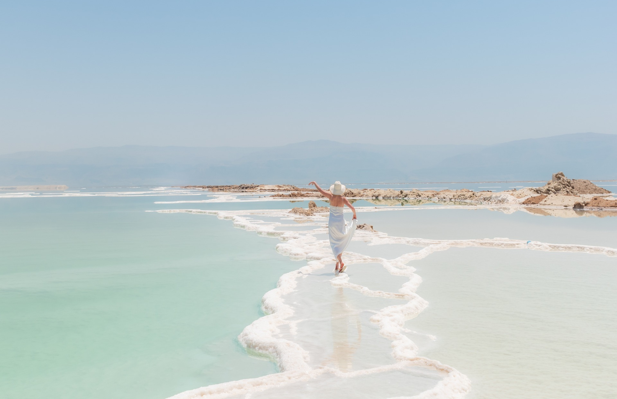 Female walking across the beach